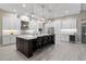 Spacious kitchen featuring a large island, stainless steel appliances, and sleek white cabinets at 209 Pine Lilly Ct, Lake Alfred, FL 33850