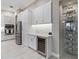 Gourmet kitchen with stainless steel appliances, granite countertops, wine cooler, and wine storage area at 209 Pine Lilly Ct, Lake Alfred, FL 33850