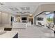 Open-concept living room featuring modern fireplace, detailed ceiling, and seamless access to the outdoor living area at 209 Pine Lilly Ct, Lake Alfred, FL 33850