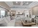 A living room with an open floor plan and stylish furnishings, connected to the kitchen and dining area at 209 Pine Lilly Ct, Lake Alfred, FL 33850
