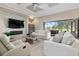 The home's living room features a modern fireplace and beautiful sliding glass doors to the outside at 209 Pine Lilly Ct, Lake Alfred, FL 33850