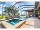 Gorgeous screened-in pool area with a waterfall feature, spa, and lush surroundings at 209 Pine Lilly Ct, Lake Alfred, FL 33850