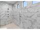 Shower featuring modern marble tile with body jets, rainfall shower head, and hand shower at 209 Pine Lilly Ct, Lake Alfred, FL 33850