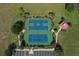 Overhead view of community tennis and basketball courts, complemented by walkways, parking, and landscaping at 209 Pine Lilly Ct, Lake Alfred, FL 33850