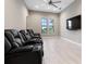 A modern media room with comfortable seating, large screen television and neutral decor for an immersive viewing experience at 209 Pine Lilly Ct, Lake Alfred, FL 33850