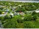 A high angle aerial view highlights the property amidst a residential neighborhood near a lake at 2480 Avenue E Sw, Winter Haven, FL 33880