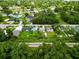 This aerial view shows the property nestled among mature trees in a quiet neighborhood with easy access to roads at 2480 Avenue E Sw, Winter Haven, FL 33880