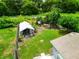 Expansive backyard with lush lawn, utility shed, mature trees, and plenty of space for outdoor activities at 2480 Avenue E Sw, Winter Haven, FL 33880