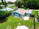 Charming single-story home features a well-maintained lawn, mature trees, and a concrete patio perfect for outdoor relaxation at 2480 Avenue E Sw, Winter Haven, FL 33880