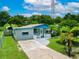 Charming single-story home with a well-manicured lawn, inviting curb appeal, and blue accents at 2480 Avenue E Sw, Winter Haven, FL 33880