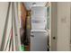 Efficient laundry room features a stackable washer and dryer, optimizing space and convenience at 2480 Avenue E Sw, Winter Haven, FL 33880