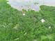 Lush acreage with mature trees, a lake, and multiple houses, offering a private and natural retreat at 2530 Arbuckle Shores Rd, Frostproof, FL 33843