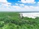 Expansive aerial view showing the property location with lakefront access amidst lush greenery at 2530 Arbuckle Shores Rd, Frostproof, FL 33843