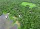 Expansive aerial view showcases a tranquil lake, lush forests, docks, and charming waterfront homes at 2530 Arbuckle Shores Rd, Frostproof, FL 33843