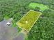 Breathtaking aerial view of a beautiful lot near a lake surrounded by lush greenery and mature trees at 2530 Arbuckle Shores Rd, Frostproof, FL 33843