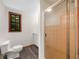 Clean bathroom featuring a glass door shower, toilet and window at 2530 Arbuckle Shores Rd, Frostproof, FL 33843