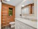 Bathroom features a modern vanity, toilet, and a window with a view at 2530 Arbuckle Shores Rd, Frostproof, FL 33843