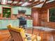 Charming kitchen features wood walls, modern appliances, and views of greenery at 2530 Arbuckle Shores Rd, Frostproof, FL 33843