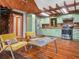 Inviting kitchen and living area featuring wood floors, exposed beams and stainless steel appliances at 2530 Arbuckle Shores Rd, Frostproof, FL 33843