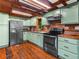 Charming kitchen with custom-painted cabinets, stainless appliances, and hardwood flooring at 2530 Arbuckle Shores Rd, Frostproof, FL 33843
