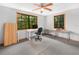Bright office space with two windows, a desk setup, and carpet at 2530 Arbuckle Shores Rd, Frostproof, FL 33843