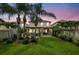 Beautiful backyard with a covered outdoor kitchen, bar, pergola, patio and lush landscaping at 2612 San Simeon Way, Kissimmee, FL 34741