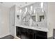 Elegant bathroom featuring a double sink vanity, modern lighting, stylish round mirrors, and neutral decor at 2612 San Simeon Way, Kissimmee, FL 34741
