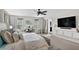 Serene bedroom featuring a large bed, neutral decor, a ceiling fan, and ample natural light at 2612 San Simeon Way, Kissimmee, FL 34741