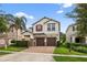 Two-story home boasts a three-car garage, manicured landscaping and architectural details at 2612 San Simeon Way, Kissimmee, FL 34741
