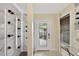 Elegant foyer with modern wine rack, stylish lighting, and a sleek glass console table at 2612 San Simeon Way, Kissimmee, FL 34741