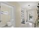 Grand foyer featuring a modern chandelier, a powder room, and a stylish wine rack at 2612 San Simeon Way, Kissimmee, FL 34741