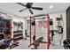Well-equipped home gym with weightlifting machines, free weights, motivational decor, and a ceiling fan at 2612 San Simeon Way, Kissimmee, FL 34741
