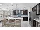 Modern kitchen with a large island, stylish pendant lighting, and stainless steel appliances at 2612 San Simeon Way, Kissimmee, FL 34741