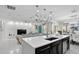Open-concept kitchen with a large island and modern design elements flowing into the living area at 2612 San Simeon Way, Kissimmee, FL 34741
