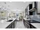 Open-concept kitchen with a large island, seamlessly connected to the dining and living areas at 2612 San Simeon Way, Kissimmee, FL 34741