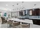 Modern kitchen with a large island, stylish pendant lighting, and stainless steel appliances at 2612 San Simeon Way, Kissimmee, FL 34741