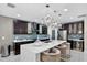 Modern kitchen with a large island, stylish pendant lighting, and stainless steel appliances at 2612 San Simeon Way, Kissimmee, FL 34741