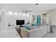 Spacious living room features a modern accent wall, tile flooring, and neutral decor with bright accents at 2612 San Simeon Way, Kissimmee, FL 34741