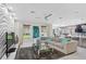Open concept living room with modern decor, large windows, and an inviting neutral colored sectional sofa at 2612 San Simeon Way, Kissimmee, FL 34741
