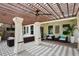 Outdoor patio area featuring covered furniture, ceiling fan, and tile flooring at 2612 San Simeon Way, Kissimmee, FL 34741