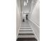 Modern staircase with white railings and black trim provides a clean and stylish transition between floors at 2612 San Simeon Way, Kissimmee, FL 34741