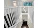 Stylish staircase with white railings and dark wood steps leads to a lower level with modern decor at 2612 San Simeon Way, Kissimmee, FL 34741