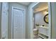 Bathroom view showcasing a vanity and toilet down a small hallway at 2835 Wingfoot Ct, Winter Haven, FL 33884
