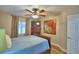 A comfy bedroom featuring a wooden bed, a dresser with a TV, and colorful wall art at 2835 Wingfoot Ct, Winter Haven, FL 33884
