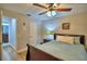 Comfortable bedroom with a ceiling fan, wood floors, and warm decor at 2835 Wingfoot Ct, Winter Haven, FL 33884