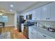 Bright kitchen features white cabinets, black appliances, and hardwood flooring at 2835 Wingfoot Ct, Winter Haven, FL 33884