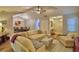 Inviting living room with vaulted ceiling, wood-look flooring, view to dining room, and comfortable furniture for relaxing at 2835 Wingfoot Ct, Winter Haven, FL 33884