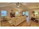 Bright living room with vaulted ceiling, fan, wood-look flooring, and a comfortable sectional sofa with natural light at 2835 Wingfoot Ct, Winter Haven, FL 33884