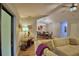 Well-lit living area featuring wood-look flooring and comfortable neutral furniture with view to dining room and open patio at 2835 Wingfoot Ct, Winter Haven, FL 33884