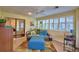 Bright living room features a comfortable futon sofa, a ceiling fan and tiled floors at 2835 Wingfoot Ct, Winter Haven, FL 33884